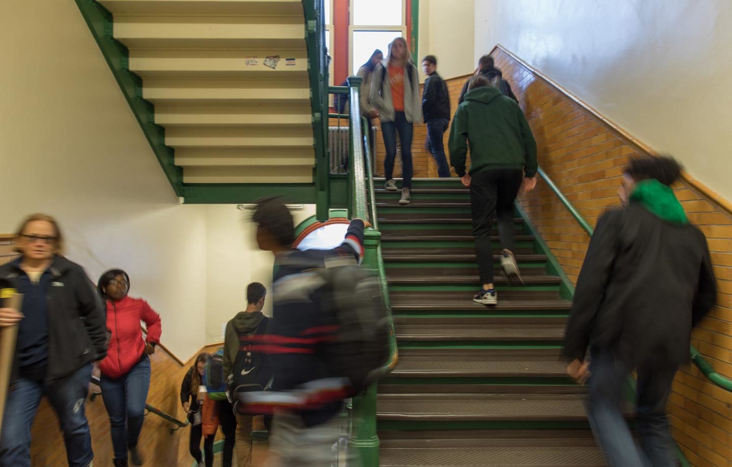 High school students walking up and down stairs as they change classes
